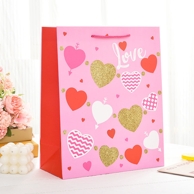 Sac en papier cadeau de logo personnalisé de marque de luxe pour vêtements de vêtements mate rose